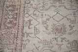 Worn texture on the angular vine field and cochineal red pawn motif border.