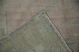 View of the hand-knotted back and secured edge of a vintage Oushak rug runner.
