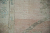 Heavy abrash in pale rose and beige with even wear down to the knot heads on a vintage Turkish runner.