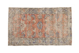 Distressed vintage Oushak rug, faded blush, pale sandalwood field, cobalt blue palmettes.