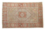 Distressed vintage Oushak rug, concentric medallions, brick red, antique ivory, and sage green.