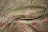 Woven texture and faded floral motifs of a vintage Oushak rug in sage green and mauve.