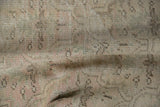Vintage distressed Oushak carpet, highlighting worn pile and faded floral palmette design.