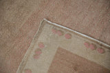 Distressed Oushak rug corner with reverse side, intact side cord, and even pile wear.