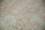 Detail of vintage distressed Sparta carpet, blush pink and ivory floral vinery with pile wear.