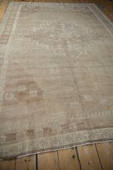 Abrashed field of a distressed vintage Oushak rug, showing subtle pattern and raised warps.