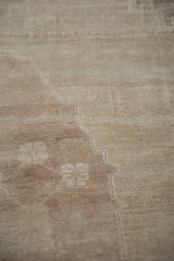 Distressed Oushak rug pile with varied beige, coffee, ivory, and oxidized silver tones.