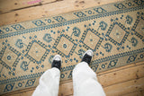 Distressed Turkish Dosemealti runner with blue geometric medallions and soft texture underfoot.