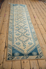 Distressed Dosemealti rug runner, sand field with blue diamond medallions and hook motifs.