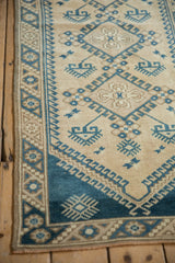 Distressed vintage Dosemealti runner with geometric hook and latch border and blue crab gul.