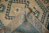 Distressed Dosemealti rug corner shows hook and latch motifs, even wear, and hand-knotted back.
