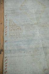 Distressed Turkish runner pile with faded powder blue, pale bronze patterns and secured edge.