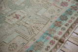 Distressed vintage Soumac carpet detail with geometric gul, pinwheel blossoms, and turquoise abrashes.