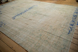 Prominent cobalt blue border on distressed vintage Oushak rug with faded cream and sea foam green field.