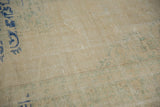 Reverse side of a vintage Oushak carpet, showing natural foundation weave with cobalt blue painted numbers.