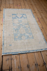 Distressed Oushak rug with soft wool pile, powder blue and ivory abrashes, side selvage.