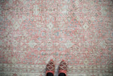 Distressed Sparta carpet texture, showing wear, dusty blush, ivory, seafoam floral motifs.