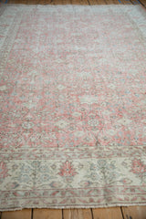 Worn distressed Sparta carpet showing blush, ivory field with faded seafoam and slate motifs.