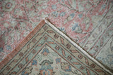 Distressed Sparta carpet close-up: worn blush, ivory, seafoam pile, reverse, and intact selvage.