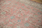 Worn floral and vine motifs and texture on a distressed pink Sparta rug.