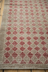 Distressed vintage Oushak rug with worn cherry red and beige diamond lattice pattern, machine bound edge.