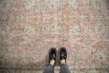 Distressed pink and ivory vintage Sparta rug with Safavid inspired floral pattern underfoot.