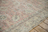 Faded pink and ivory Safavid-inspired floral design with visible foundation on a distressed vintage Sparta rug.