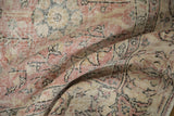 Textural detail of vintage distressed Sparta carpet, worn floral patterns, exposed foundation, muted pink, beige.
