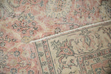 Distressed pink and beige pile, showing foundation, with clear hand-knotted reverse.
