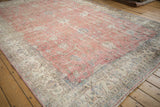 Textured distressed pink field with visible foundation and elegant ivory floral border.