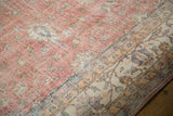 Vintage distressed Sparta carpet detail, showing worn blush field, ivory border, and machine-bound edge.