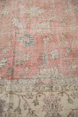 Distressed texture of a blush pink floral field with light beige border.