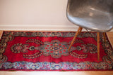 Vintage Persian Kerman rug in hot pink looking red with ornate blue floral patterns, 2'6