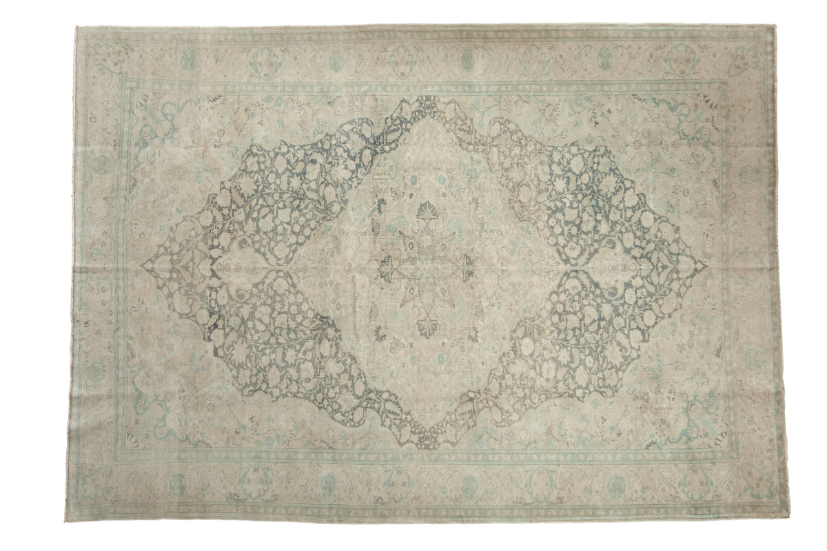 Distressed vintage Kayseri carpet with a starburst medallion design in soft slate blue and ivory tones.