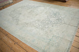 Angled view of the distressed Kayseri rug's large floral medallion design.