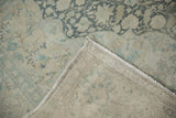 Folded corner of a vintage Kayseri rug revealing the cotton foundation and intact side cord selvage.