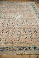 Distressed vintage Hamadan carpet's Herati motif with blush and dark navy tones.