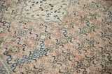 Distressed Hamadan carpet field featuring traditional Herati motif in dusty rose, navy, and teal.