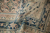 Distressed vintage Hamadan rug, showing softened dusty rose, navy, and teal Herati field patterns.