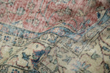 Distressed vintage Sparta carpet: worn dusty red pile, ivory field, and blue floral details.