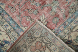 Vintage Distressed Sparta carpet corner showing worn red floral pile, ivory foundation, machine-bound edge.