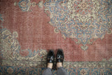 Distressed Turkish Sparta rug with dusty burgundy field, visible foundation wear, blue motifs.