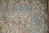 Distressed Turkish Sparta carpet detail, showing wear on blue, burgundy, and ivory scrolling patterns.