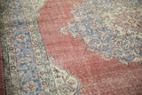 Decorative distressed texture of a vintage Turkish Sparta rug, featuring burgundy, blue, and ivory motifs.