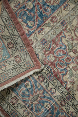 Distressed Turkish Sparta carpet: textured pile, exposed foundation, side selvage, worn fringe.