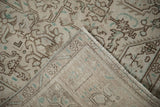 Distressed Tabriz carpet pile with geometric arabesques, visible foundation, and bound edge.