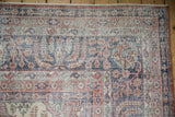 Corner detail of a vintage Sparta carpet's weeping willow border with a distressed low pile.