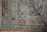 A folded corner showing the worn pile and hand-knotted back of a vintage Sparta rug.