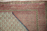Vintage Hamadan rug corner: dusty blue botehs, fuchsia zig-zag patterns, and faint foundation showing.