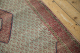 Repeating magenta blossoms on dusty powder blue field, faint wear, and raspberry red meandering border.